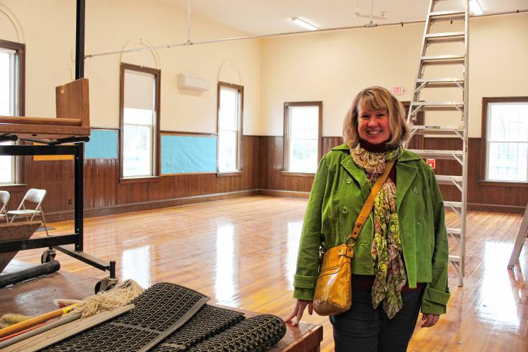 Tilton Library Director Candace Bradbury-Carlin stands in the South Deerfield Congregational Church’s function hall, which will serve as the library’s temporary home while its expansion project gets underway.