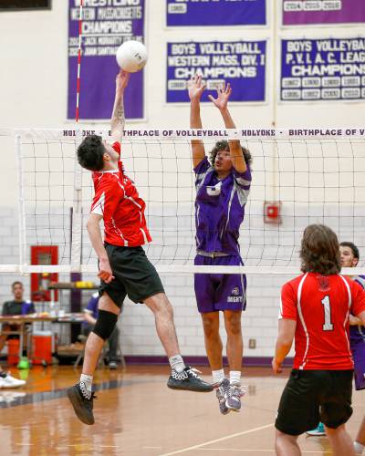 Athol’s Colin Mason (11) tips the ball at the net over Holyoke’s YandielRiveraTroche (8) in the second set Friday in Holyoke.