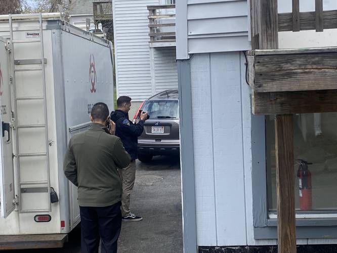Massachusetts State Police detectives enter an apartment at 92 Chapman St. in Greenfield, the former home of murder suspect Taaniel Herberger-Brown, as a biohazard crew investigates the scene.