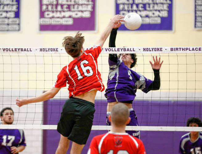 Athol’s Ethan Goodwin (16) registers a kill over Holyoke’s Adrian Centeno-Feliciano (4) in the second set Friday in Holyoke.