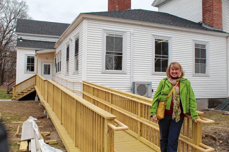 Tilton Library Director Candace Bradbury-Carlin stands on the new accessibility ramp leading up to the South Deerfield Congregational Church, which will serve as the library’s temporary home while its expansion project gets underway.
