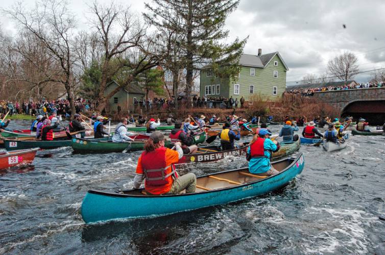 Canoes approach the bridge in Athol at the start of the River Rat Race on Saturday.