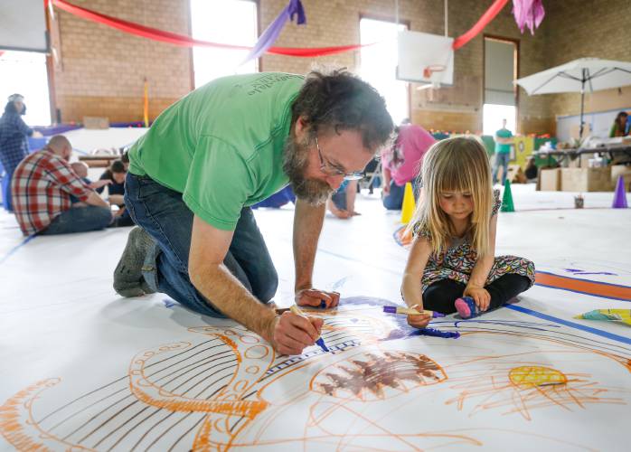 Brendan Flannelly-King, left, draws on the floor with Ida Westley, then 3, during the 2018 Hilltown Draw-Around event. This year’s event will be held on Saturday, April 27, from noon to midnight.