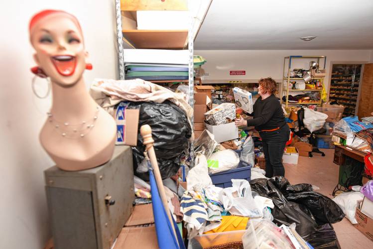 Shop manager Marlene Lavelle goes through boxes of fabrics at The Stash House in Turners Falls.