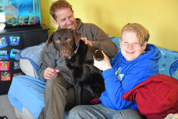 Chris Sanborn with his son Rain, and emotional support dog Zeal.