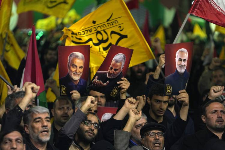 Iranian protesters chant slogans as they hold up posters of the late Iranian Revolutionary Guard Gen. Qassem Soleimani, who was killed in a U.S. drone attack in 2020, during their anti-Israeli gathering to condemn killing members of the Iranian Revolutionary Guard in Syria, at the Felestin (Palestine) Sq. in downtown Tehran, Iran, Monday, April 1, 2024.