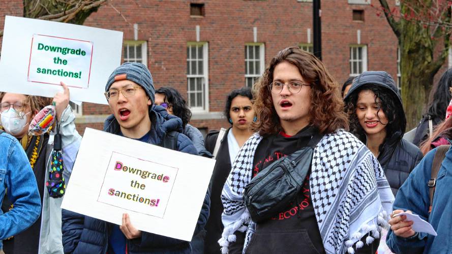 Nicolás Cardona, right, a member of the UMass Students for Justice in Palestine, joins other protesters at a rally held Thursday in front of the school’s Whitmore Administration Building, to demand an end to probations for students arrested at a sit-in protest against the war in Gaza in October. 