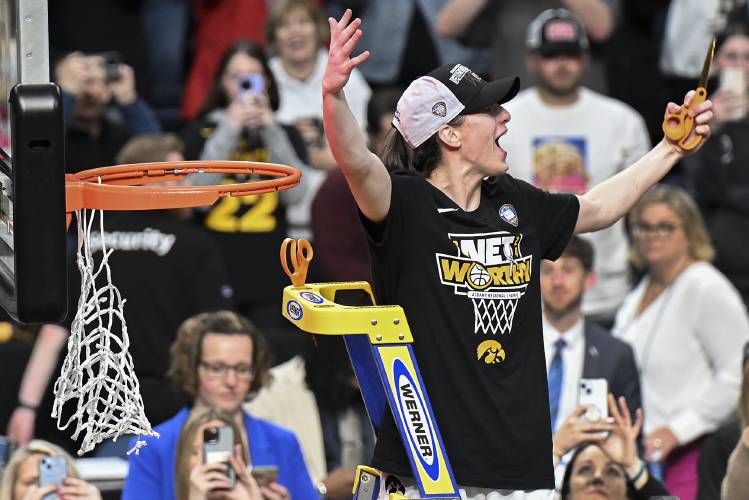 Iowa guard Caitlin Clark reacts to the crowd before cutting a piece of the net after Iowa defeated LSU in an Elite Eight round college basketball game during the NCAA Tournament, Monday, April 1, 2024, in Albany, N.Y. (AP Photo/Hans Pennink)