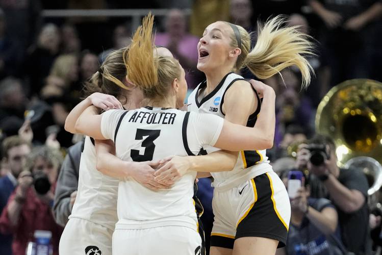 Iowa players celebrate after defeating LSU in an Elite Eight round college basketball game during the NCAA Tournament, Monday, April 1, 2024, in Albany, N.Y. (AP Photo/Mary Altaffer)
