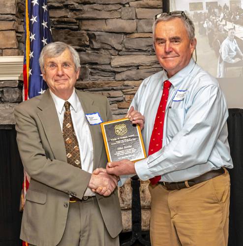 Orange resident Mike Roche (left) receives the Words of Wisdom Award from Bill Davis, vice president of the Worcester County League of Sportsmen’s Clubs, at its annual banquet on March 23.
