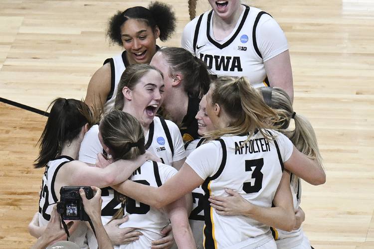 Iowa players celebrate after defeating LSU in an Elite Eight round college basketball game during the NCAA Tournament, Monday, April 1, 2024, in Albany, N.Y. (AP Photo/Hans Pennink)
