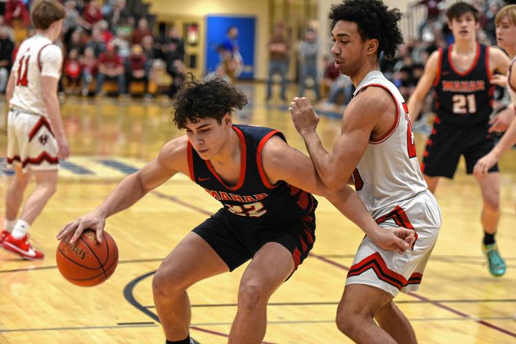 Mahar’s Jayden Delgado (22), left, backs down Hoosac Valley’s Qwanell Bradley during the Senators’ 76-44 loss in the MIAA Division 5 semifinals on Tuesday at West Springfield High School.