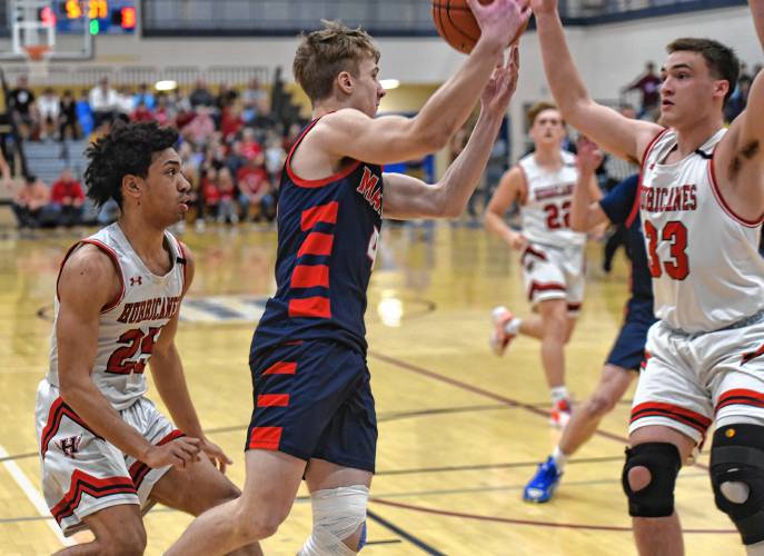 Mahar’s Lucas Isrow tries to make a pass in between Hoosac Valley’s Frank Field (33) and Qwanell Bradley (25) during the Senators’ 76-44 loss in the MIAA Division 5 semifinals on Tuesday at West Springfield High School.