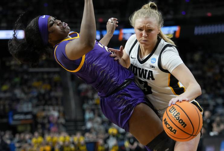 Iowa guard Sydney Affolter (3) drives against LSU guard Aneesah Morrow (24) during the first quarter of an Elite Eight round college basketball game during the NCAA Tournament, Monday, April 1, 2024, in Albany, N.Y. (AP Photo/Mary Altaffer)