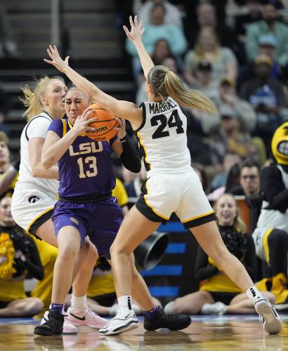 LSU guard Last-Tear Poa (13) drives to the basket against Iowa guard Gabbie Marshall (24) during the first quarter of an Elite Eight round college basketball game during the NCAA Tournament, Monday, April 1, 2024, in Albany, N.Y. (AP Photo/Mary Altaffer)