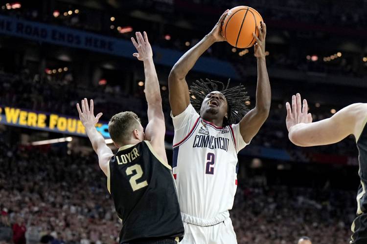 UConn guard Tristen Newton, right, is fouled by Purdue guard Fletcher Loyer during the first half of the NCAA college Final Four championship basketball game, Monday, April 8, 2024, in Glendale, Ariz. (AP Photo/Brynn Anderson)