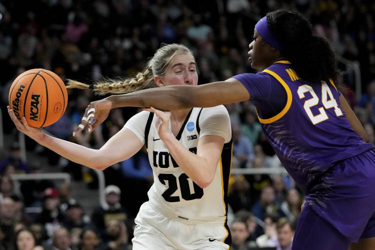 LSU guard Aneesah Morrow (24) tries to strip the ball from Iowa guard Kate Martin (20) during the first quarter of an Elite Eight round college basketball game during the NCAA Tournament, Monday, April 1, 2024, in Albany, N.Y. (AP Photo/Mary Altaffer)