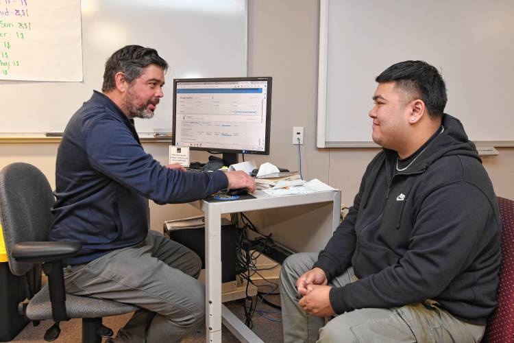 Max Fripp, director of the BEACON Learning Program at Greenfield Community College, talks with Greenfield High School student Eric Duong at the college on last week.