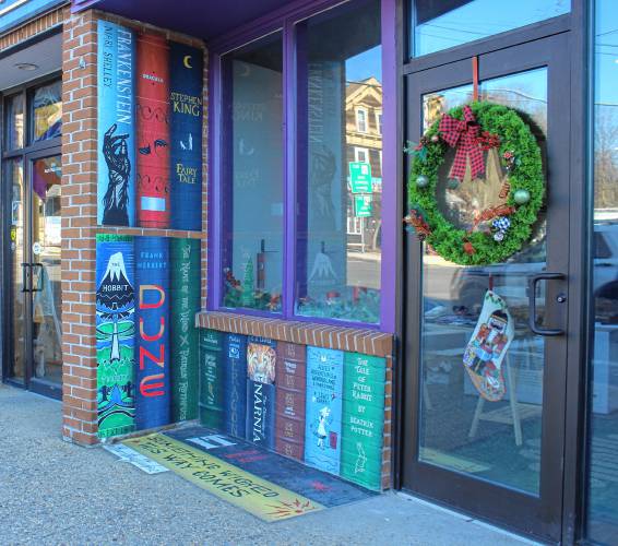Tyler Hauth commissioned Joey Burr, of BurrstingStudioz, to craft a mural of a bookshelf outside his shop, The Book Forge, which is scheduled to have a grand opening at 3 South Main St. in Orange on Jan. 1.