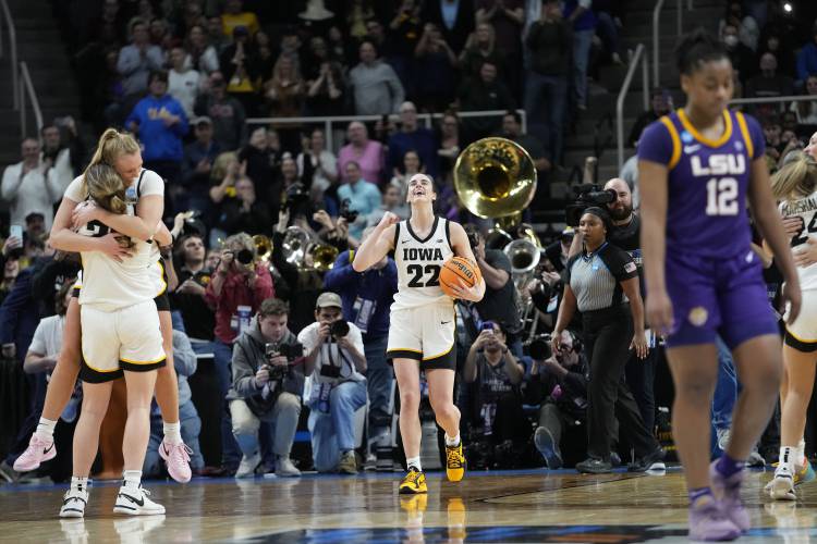 Iowa guard Caitlin Clark (22), guard Sydney Affolter (3) and Iowa guard Kate Martin (20) celebrate after defeating LSU in an Elite Eight round college basketball game during the NCAA Tournament, Monday, April 1, 2024, in Albany, N.Y. (AP Photo/Mary Altaffer)
