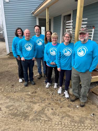 Members of the Greenfield Cooperative Bank senior management team recently volunteered to help paint a Pioneer Valley Habitat for Humanity house. They are, from left, Jackie Charron, Jeremy Payson, Kevin Bowler, Lisa Kmetz, Mary Rawls, Jane Wolfe and Michael Turley.