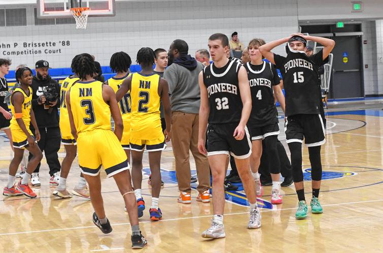 The Pioneer boys basketball team heads back to the bench after congratulating New Mission following the MIAA Division 5 boys basketball state semifinal game at Worcester State University on Wednesday.