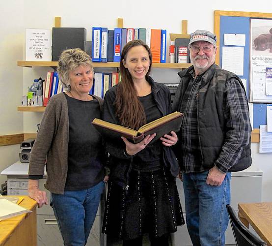 From left, Wendell Historical Society board member Pamela Richardson, Town Clerk Anna Wetherby and Historical Society board member Ed Hines with a 500-page volume the society recently returned to the town.