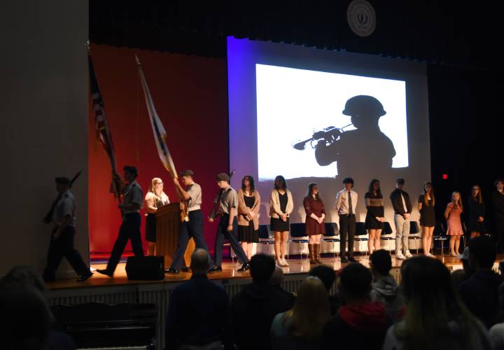 Members of Ralph C. Mahar Regional School’s Army Junior Reserve Officers’ Training Corps program retire the colors after a Veterans Day assembly in the school auditorium in November. The Junior ROTC will participate in competitions with an air rifle aspect next year.