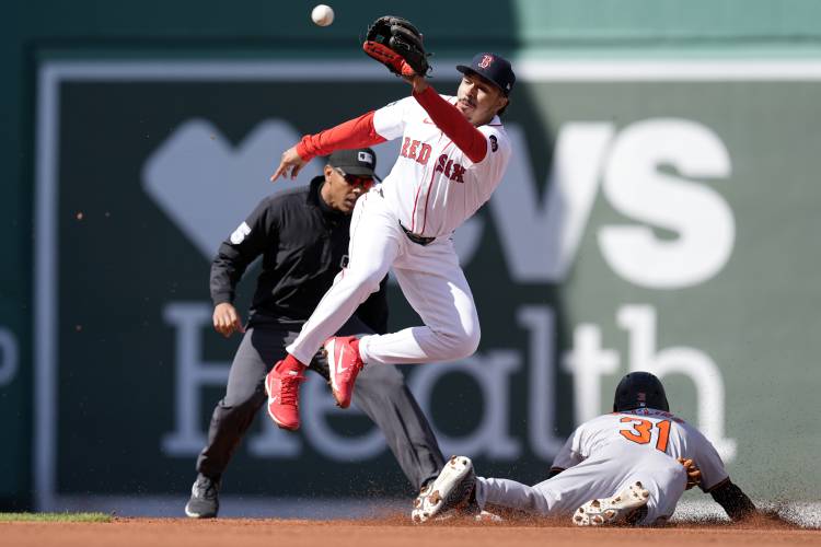 Baltimore Orioles' Cedric Mullins (31) steals second base as Boston Red Sox's David Hamilton gets the late throw during the second inning of an opening day baseball game at Fenway Park, Tuesday, April 9, 2024, in Boston. (AP Photo/Michael Dwyer)