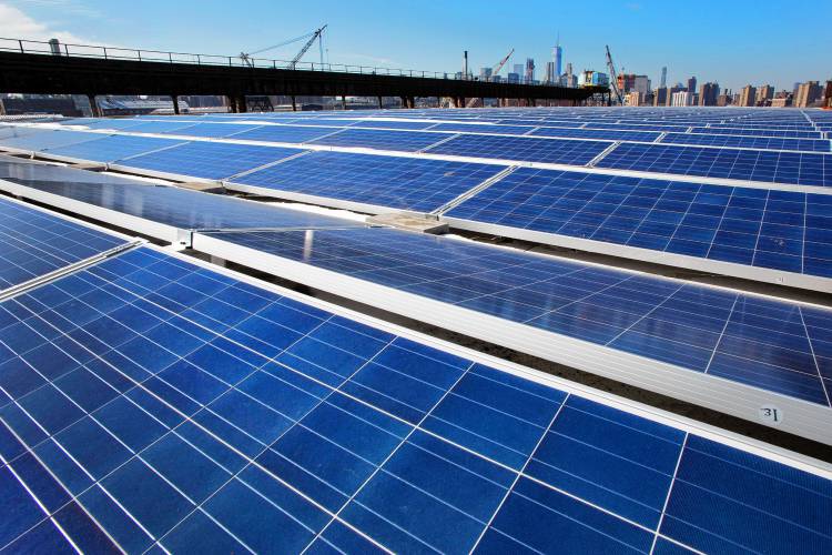A rooftop is covered with solar panels at the Brooklyn Navy Yard, Tuesday, Feb. 14, 2017, in New York.