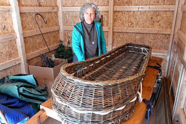 Judith Lorei of the Montague Cemetery Commission with a willow burial basket made by Mary Lauren Fraser of Turners Falls at Highland Woods Natural Burial Ground on Millers Falls Road.