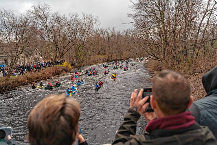 Spectators lining the Millers River and the Main Street bridge in Athol watch the start of the 59th running of the River Rat Race from Athol to Orange on Saturday.