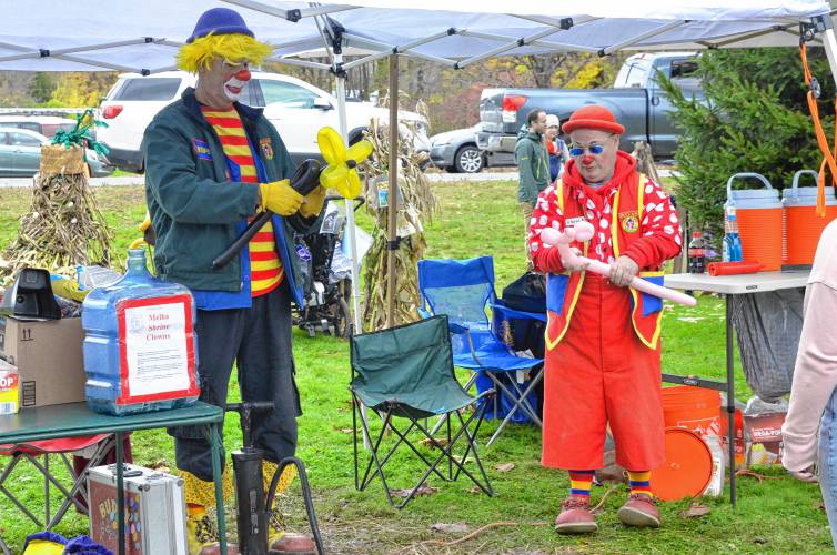 The Melha Shrine Clowns make balloon figures for the 19th annual Scarecrow in the Park festival at Cushman Park in Bernardston.