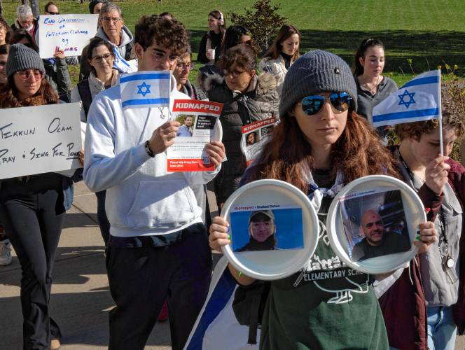 Participants during the “Bring Them Home” event sponsored by UMass Hillel. The participants carried plates with flyers attached. Each plate was taped to tables in a symbolic ritual of Shabbat honoring the 240 hostages kidnapped from Israel by Hamas.