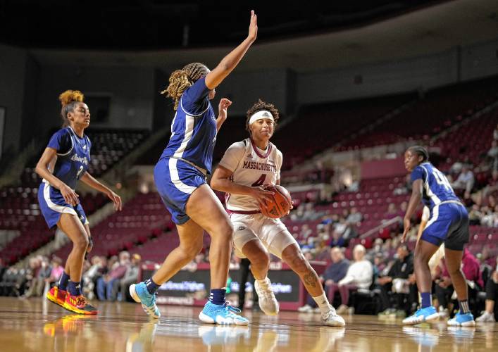 UMass’ Lilly Ferguson (4) drives to the basket  against Saint Peter’s during the Minutewomen’s season-opening victory on Monday at the Mullins Center in Amherst.