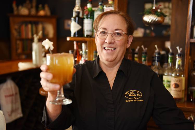 Lisa Kloc, owner/manager at The Whately Inn, with a Spiced Cider Christmas Punch at the bar at the Whately eatery. 