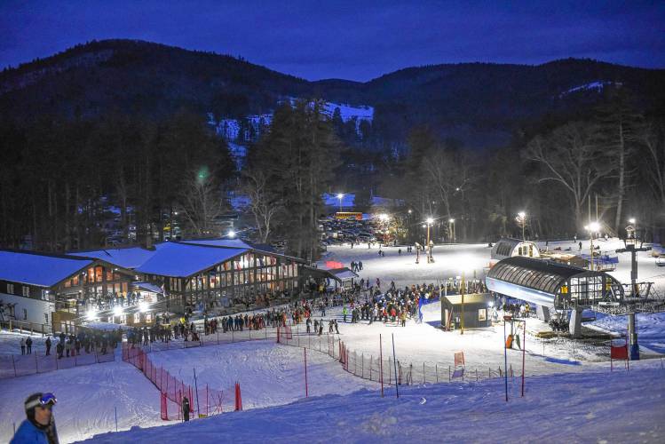 Racers queue up to take the detachable lift to the top during an evening high school ski meet at Berkshire East Mountain Resort in Charlemont.