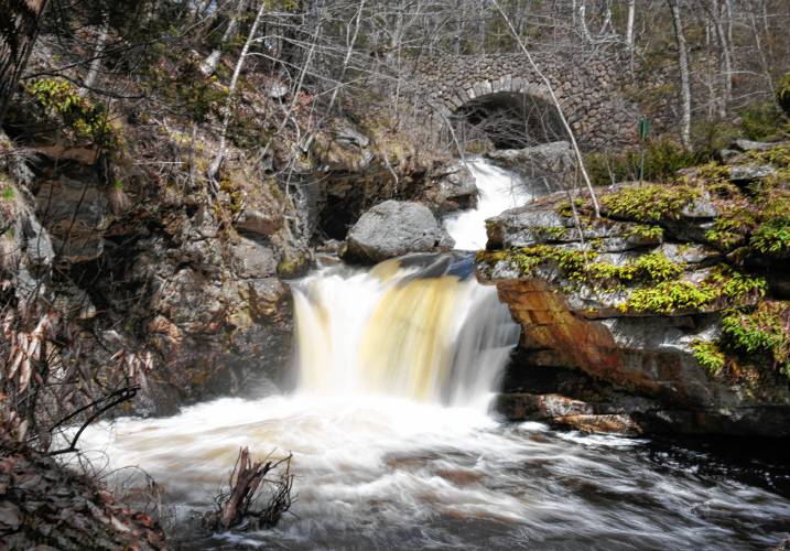 Doane’s Falls on the swollen Lawrence Brook cascades from under a stone bridge on its way to Tully Lake in Royalston.
