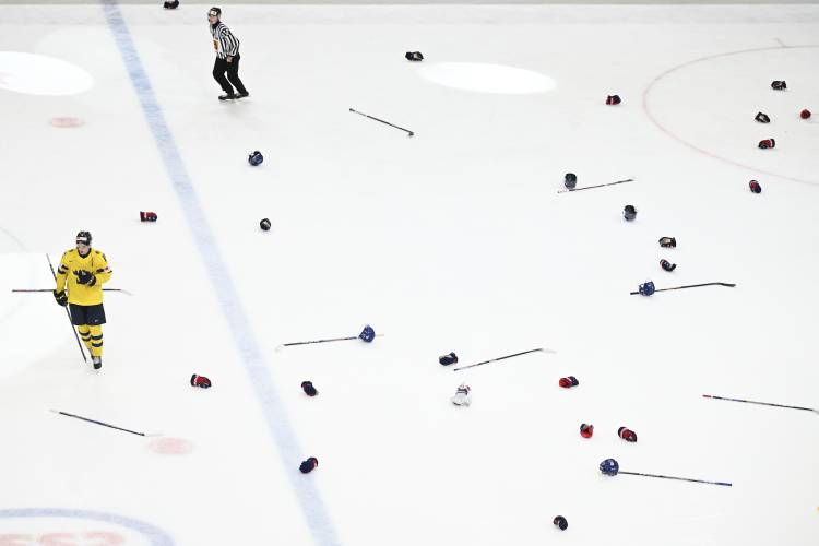 Helmets and sticks on the ice after the IIHF World Junior Championship ice hockey final match between Sweden and USA at Scandinavium in Gothenburg, Sweden, Friday Jan. 5, 2024. (Bjorn Larsson Rosvall/TT via AP)