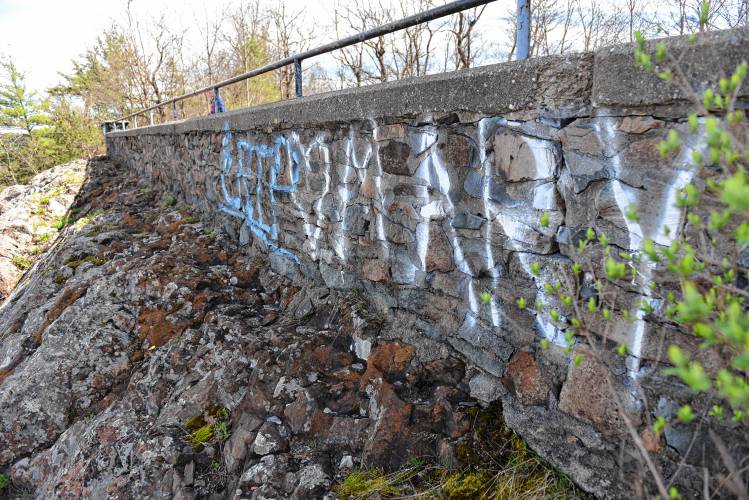 Graffiti visible from Beacon Field on the wall of the parking lot at Poet’s Seat Tower in Greenfield.