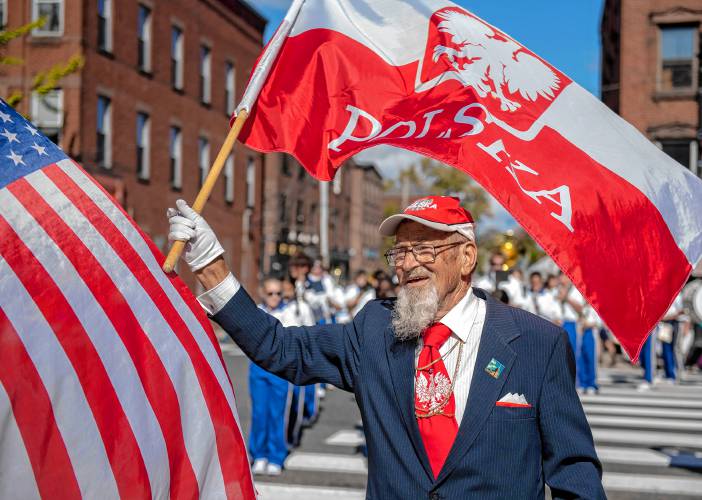 Frank Chmura, 91, of Holyoke waves a Polish flag during the Pulaski Day Parade through Main Street Northampton on Oct. 9, 2023.