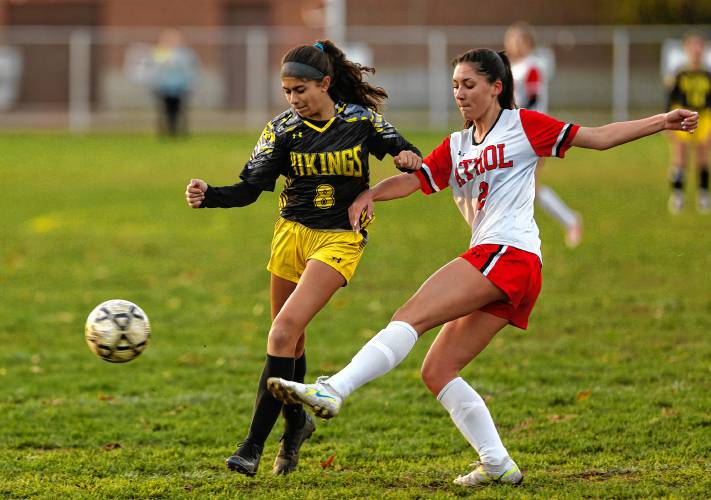 Athol defender Aubrielle Brockney (2) clears the ball away from Smith Vocational’s Monique Fredette (8) in the second half Friday in Northampton.
