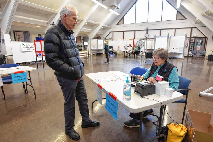 Resident William Hamer is checked in by volunteer Marge Michalski during Deerfield’s special election on Tuesday.