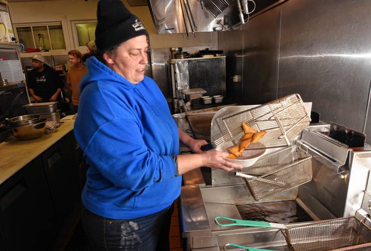 Evelyn Wulfkuhle at her restaurant, Harvey’s, in Turners Falls, frying up some sopapillas, which she pairs with local honey.