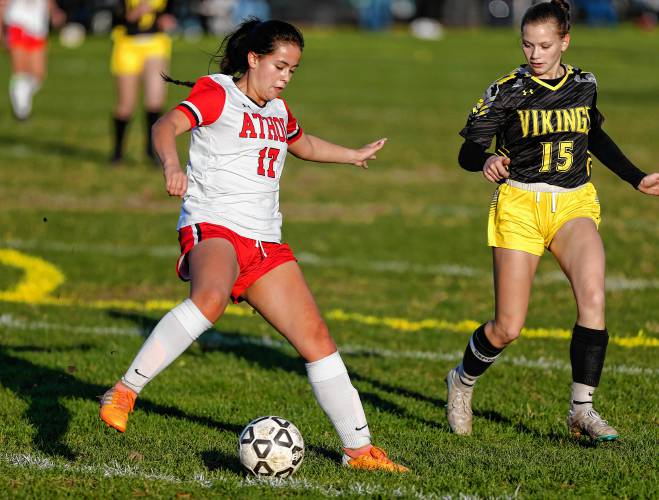 Athol’s Allison Robertson (17), left, dribbles the ball under pressure from Smith Vocational’s Caitlin Willard (15) in the first half Friday in Northampton.