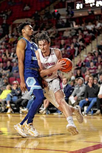 UMass’ Matt Cross (33) goes to the basket against Rhode Island during the Minutemen’s 81-79 victory on Sunday at the Mullins Center in Amherst.