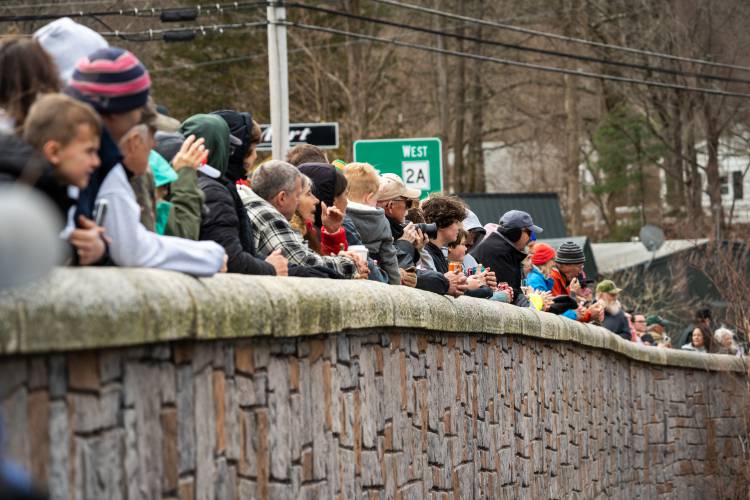 Eager fans line the Main Street bridge in Athol for the start of the annual River Rat Race on Saturday.