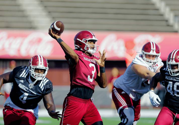UMass quarterback Taisun Phommachanh (3) throws downfield during practice Friday morning at McGuirk Alumni Stadium in Amherst.