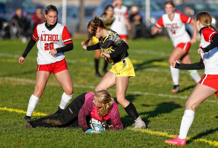 Athol goalkeeper Ava Adams dives on the ball to stop a breakaway shot from Smith Vocational’s Caitlin Willard (15) in the first half Friday in Northampton.