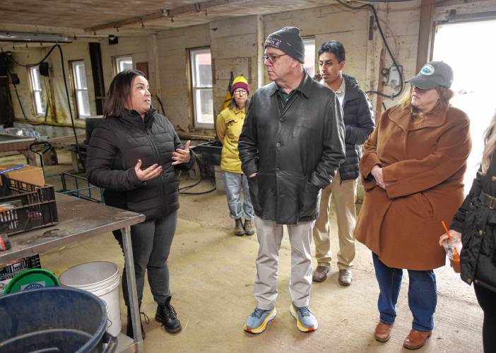 Laura Fisher, executive director of Just Roots farm in Greenfield, left, talks about the state of the barn the farm uses with Congressman Jim McGovern and Rep. Susannah Whipps on Friday during a site visit.
